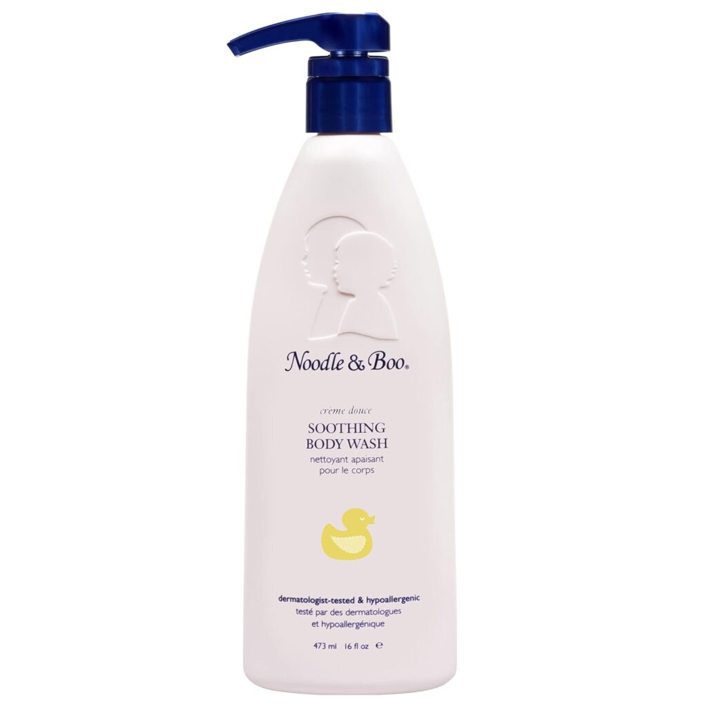 A white bottle of Noodle & Boo baby body wash with a blue pump, featuring a yellow duck illustration and product details in English and French on the label—a gentle choice for premium beauty care.
