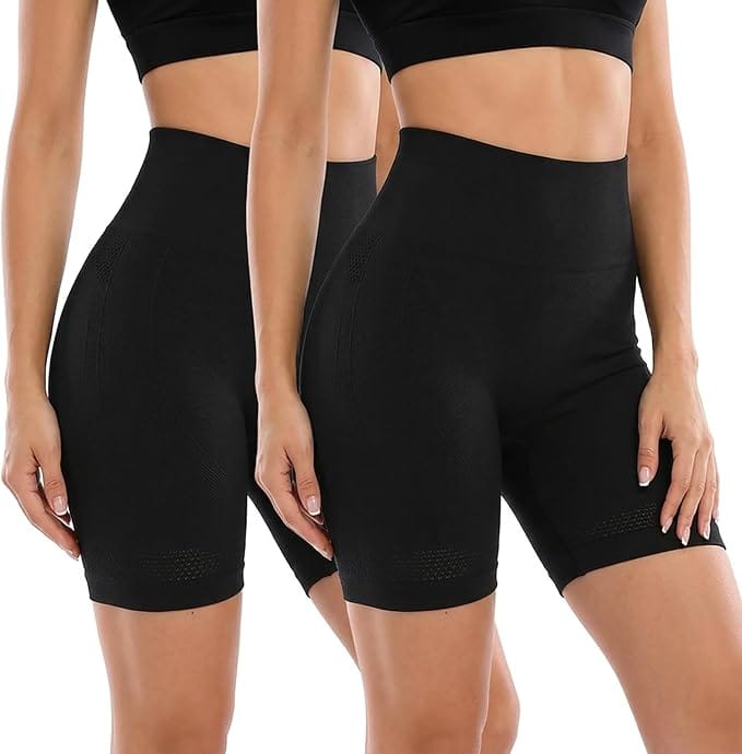 Two women wearing high-waisted, black seamless shapewear shorts and black crop tops, standing side by side against a white background.