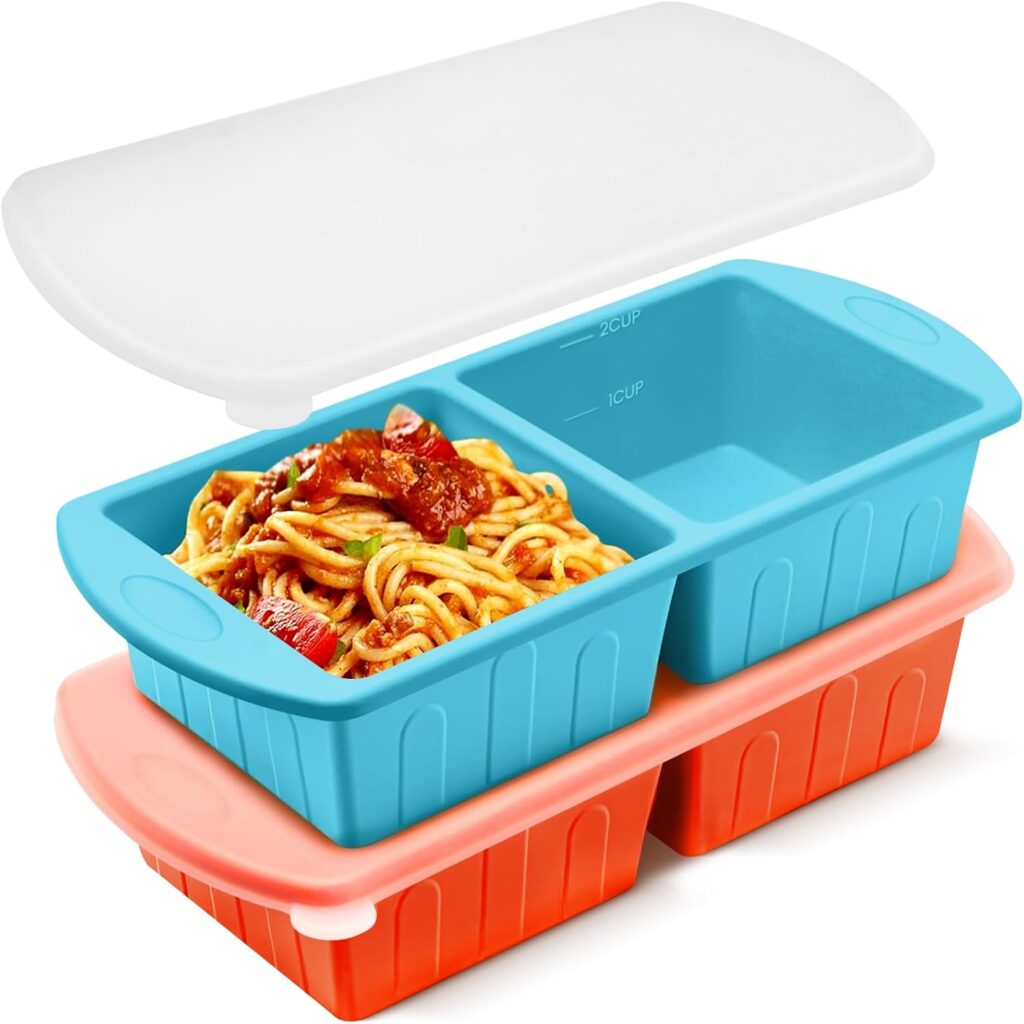 A set of divided silicone microwave containers, perfect for storing leftovers from Tuesday Deals, features one compartment filled with spaghetti. The blue containers are stacked above the orange ones, with a white lid placed on top. Measurement markings are visible inside the containers.