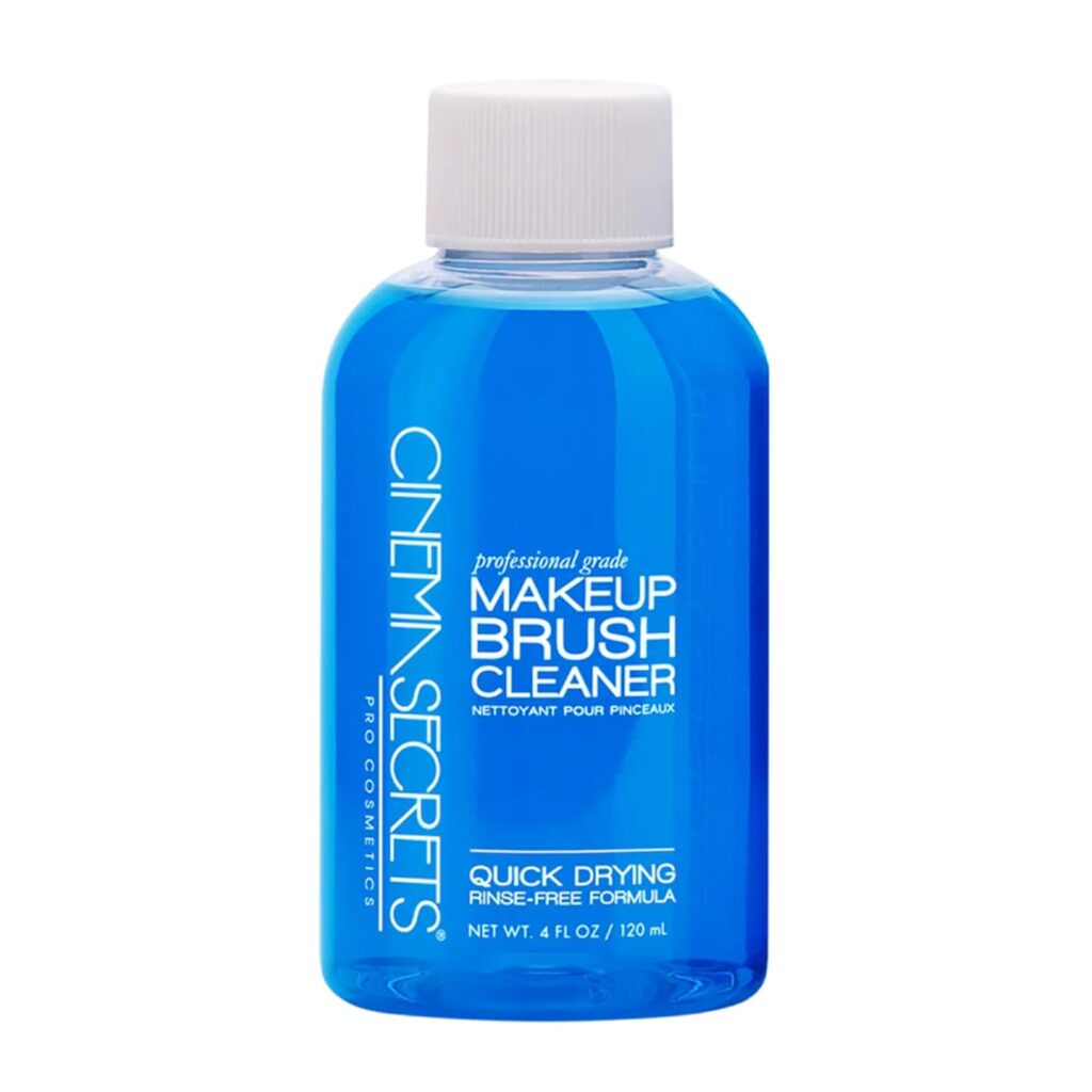 A blue 4 oz bottle of Cinema Secrets Makeup Brush Cleaner with a clear screw cap and white text label indicating it is a quick drying, rinse-free formula for cleaning makeup brushes.