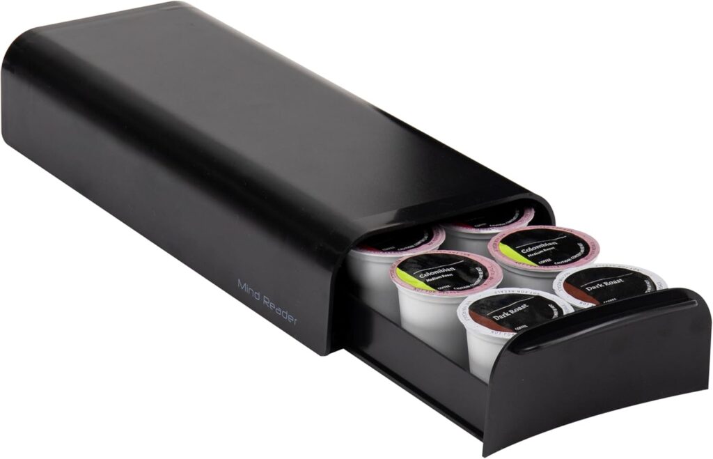 A black storage drawer is partially open, revealing several coffee pods organized inside. Perfect for Wednesday Deals, the drawer is designed to fit under a coffee machine for convenient pod storage.
