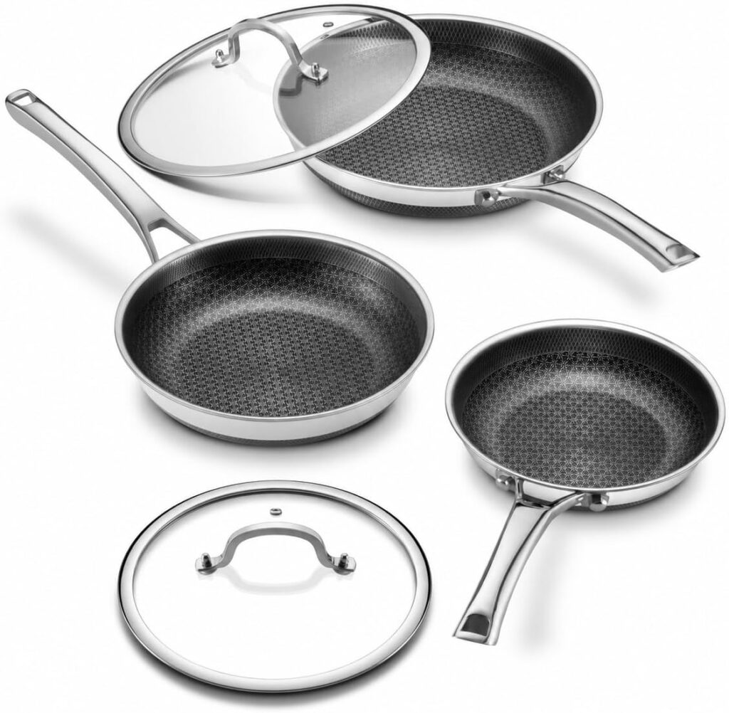 Three stainless steel frying pans with honeycomb-patterned nonstick surfaces and two glass lids with metal handles, all arranged on a white background—perfect for upgrading your kitchen during Wednesday Deals.