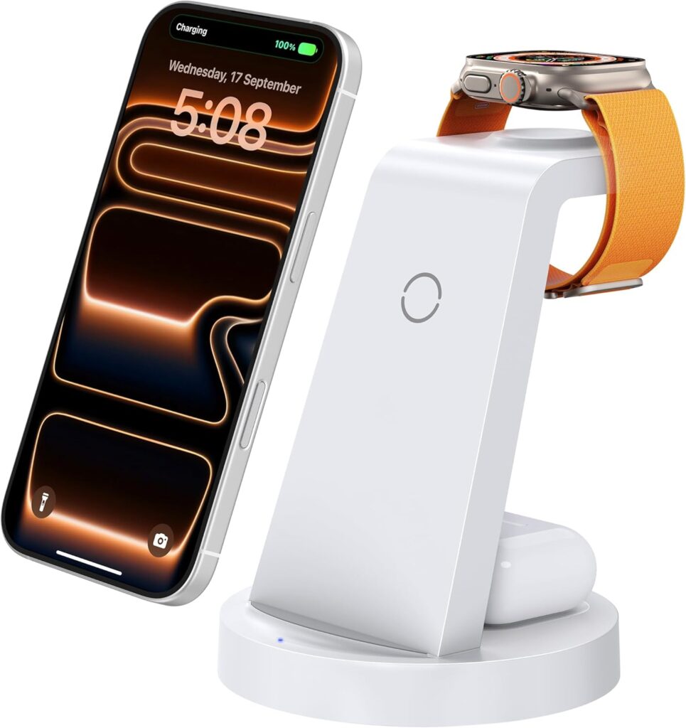 A white 3-in-1 wireless charging stand powers an iPhone, Apple Watch with an orange band, and AirPods—all displayed on the charger with the phone screen lit up. Perfect for snagging in this week’s Monday Deals.
