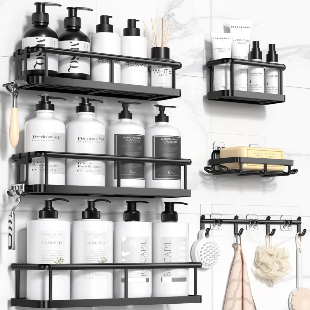 Black wall-mounted bathroom shelves hold bottles, soap, jars, and a reed diffuser. Hooks below hang towels, a brush, and bath sponge—all set against white tiles. Refresh your space with these Monday Deals.