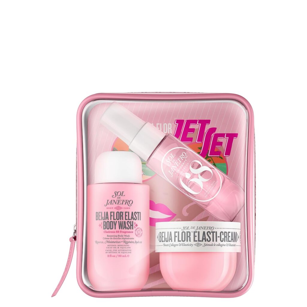 A pink Sol de Janeiro gift set including Beija Flor Elasti-Cream, body wash, fragrance mist, and a pink zippered pouch with "Jet Set" and colorful graphics on the packaging.