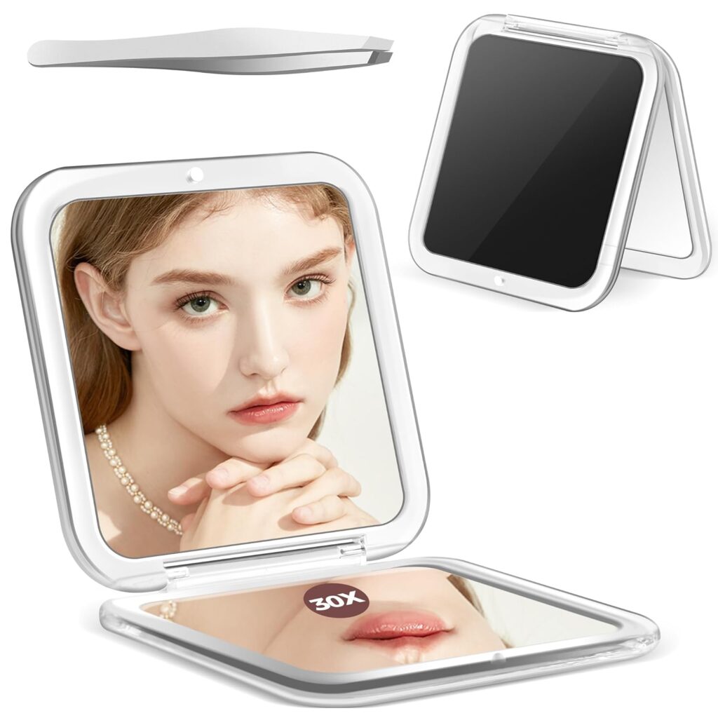 A compact square makeup mirror with a close-up reflection of a woman's face, a pair of tweezers above it, and another mirror shown standing open. The lower mirror is labeled "30X" for magnification—perfect for Monday Deals savings.