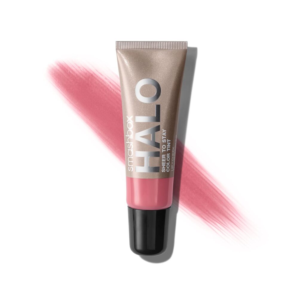 A tube of Smashbox Halo Sheer to Stay Color Tint in a pink shade, lying on a white background with a swatch of pink behind it—perfect for snagging in the latest Monday Deals.