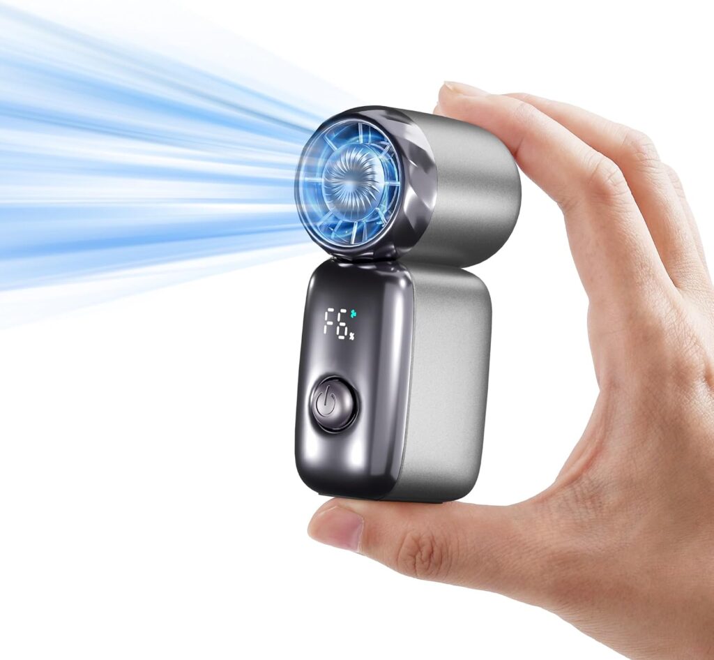 A hand holds a small, metallic portable fan with a digital display, power button, and blue airflow coming from the circular fan blades—a perfect pick for Tuesday Deals.