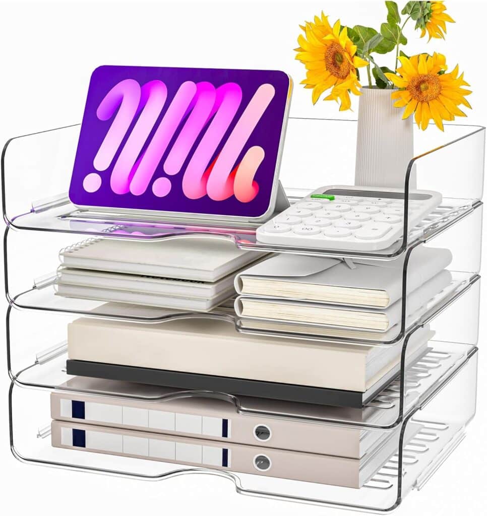 A clear acrylic desk organizer holds a tablet, calculator, vase with yellow flowers, notebooks, and file folders on four stacked trays—perfect for keeping your workspace tidy and bright during Tuesday Deals.