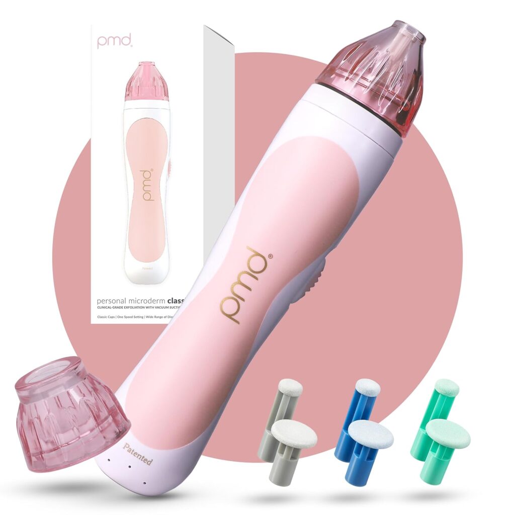 A pink and white PMD personal microdermabrasion device is shown with interchangeable heads and colorful discs. The device box stands in the background against a pink circle—perfect for scoring big savings during Monday Deals.