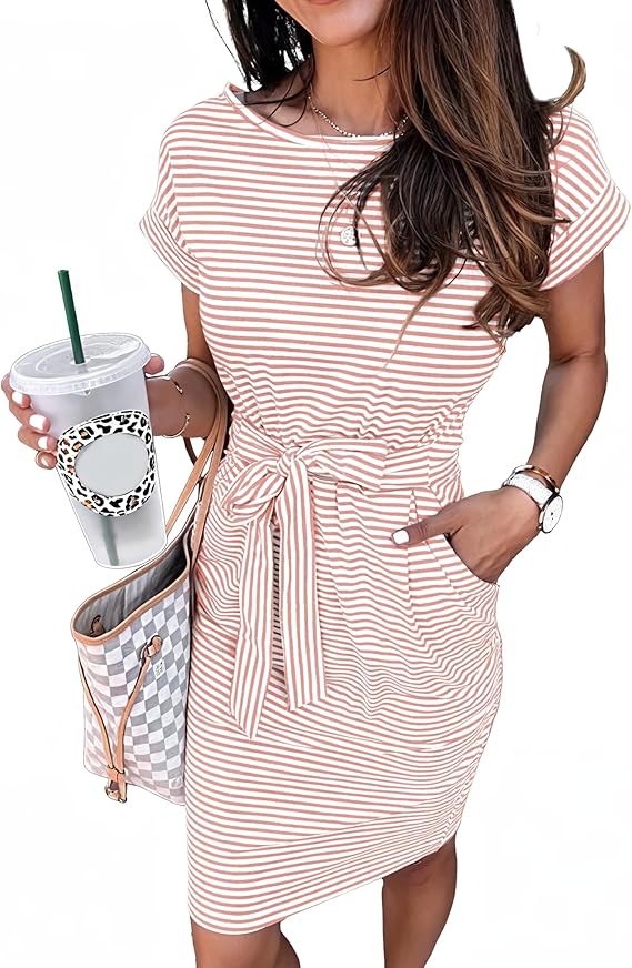Woman wearing a short-sleeve, pink and white striped dress with a waist tie, holding a checkered tote bag and a drink cup. She has long brown hair and accessorizes with a bracelet and watch.