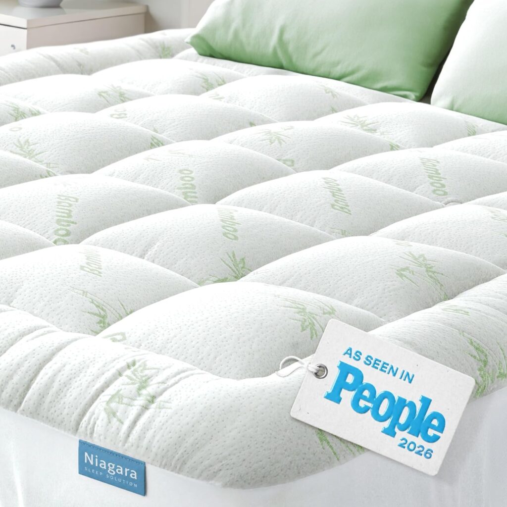 Close-up of a quilted white mattress topper with a bamboo leaf pattern and "Niagara Sleep Solution" logo. A tag reads "As Seen in People 2026." Don’t miss exclusive Monday Deals on this luxurious bedding essential.