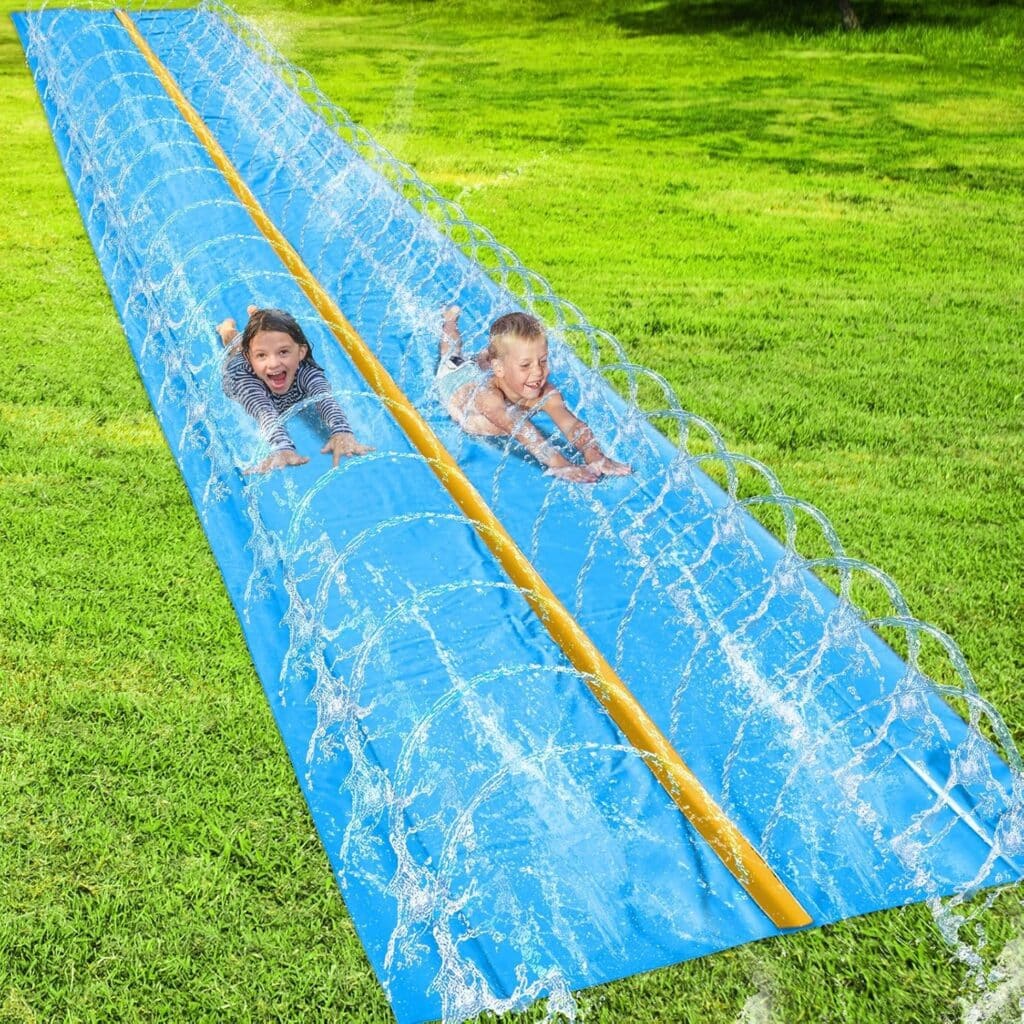 Two children slide down a blue double water slide on green grass, surrounded by arched sprays of water, smiling and enjoying a sunny outdoor day—making the most of fun and laughter with Tuesday Deals.