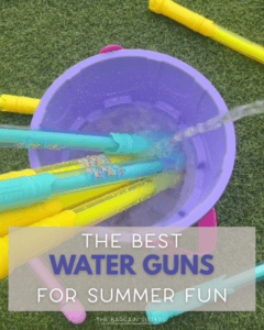 A purple bucket filled with colorful water guns being filled with water on green grass. Text overlay reads: "The Best Water Guns for Summer Fun – The Bargain Sisters.