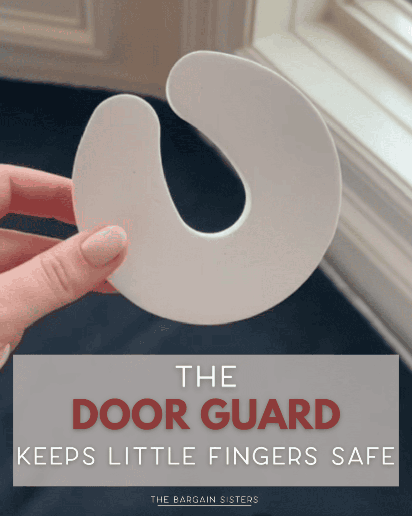 A hand holds a white, C-shaped foam door guard near a window. Text overlay reads, “The door guard keeps little fingers safe. The Bargain Sisters.”.