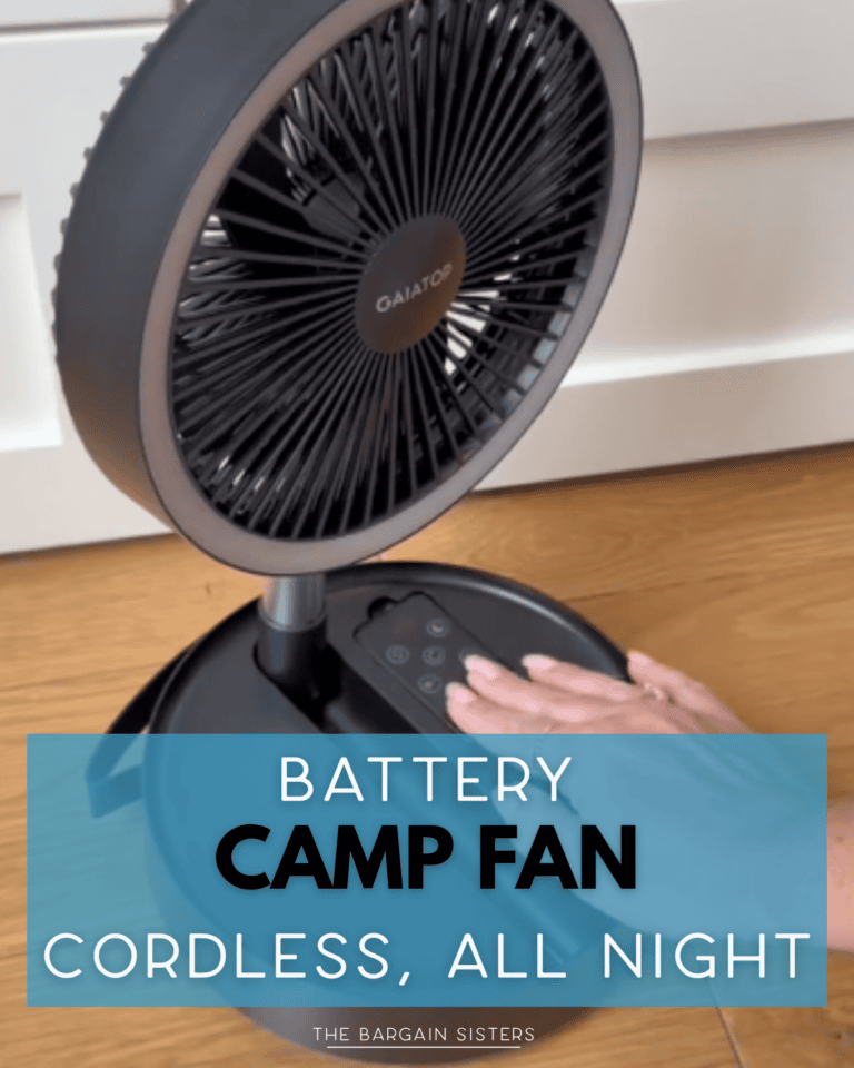A person adjusting the controls on a black GAITOP battery-powered camp fan placed on a wooden floor. Text overlay reads: "Battery Camp Fan. Cordless, All Night.