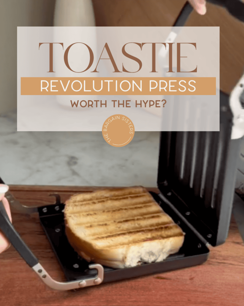 A person lifts a toasted sandwich from a black toastie press on a wooden countertop. Text over the image reads, "Toastie Revolution Press: Worth the Hype?.