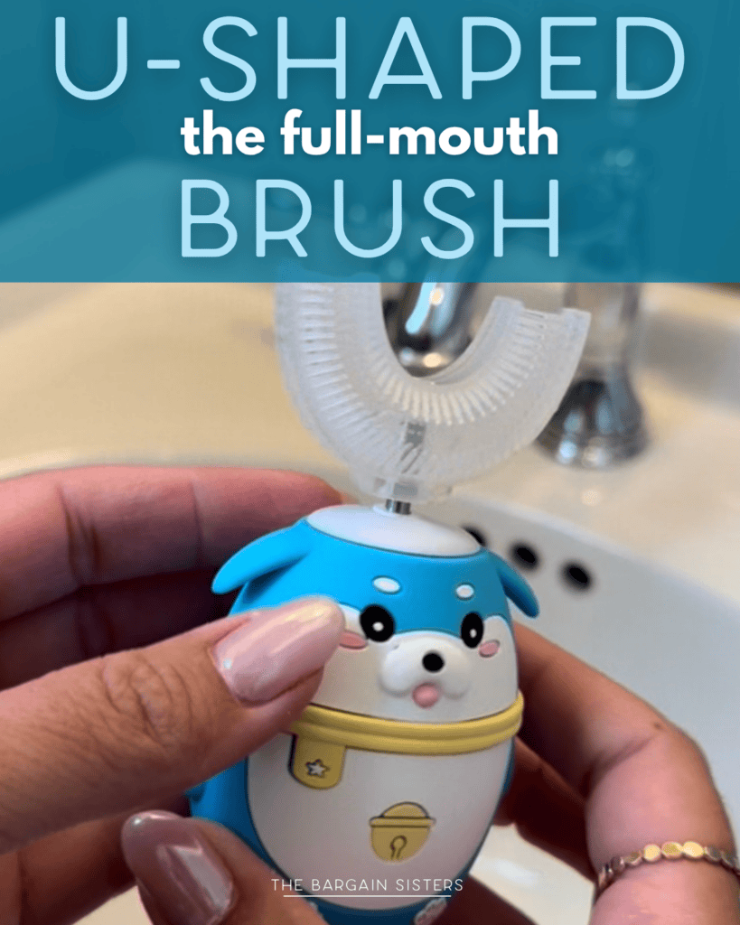 A person holds a cute, blue U-shaped full-mouth toothbrush shaped like a seal, in front of a bathroom sink.