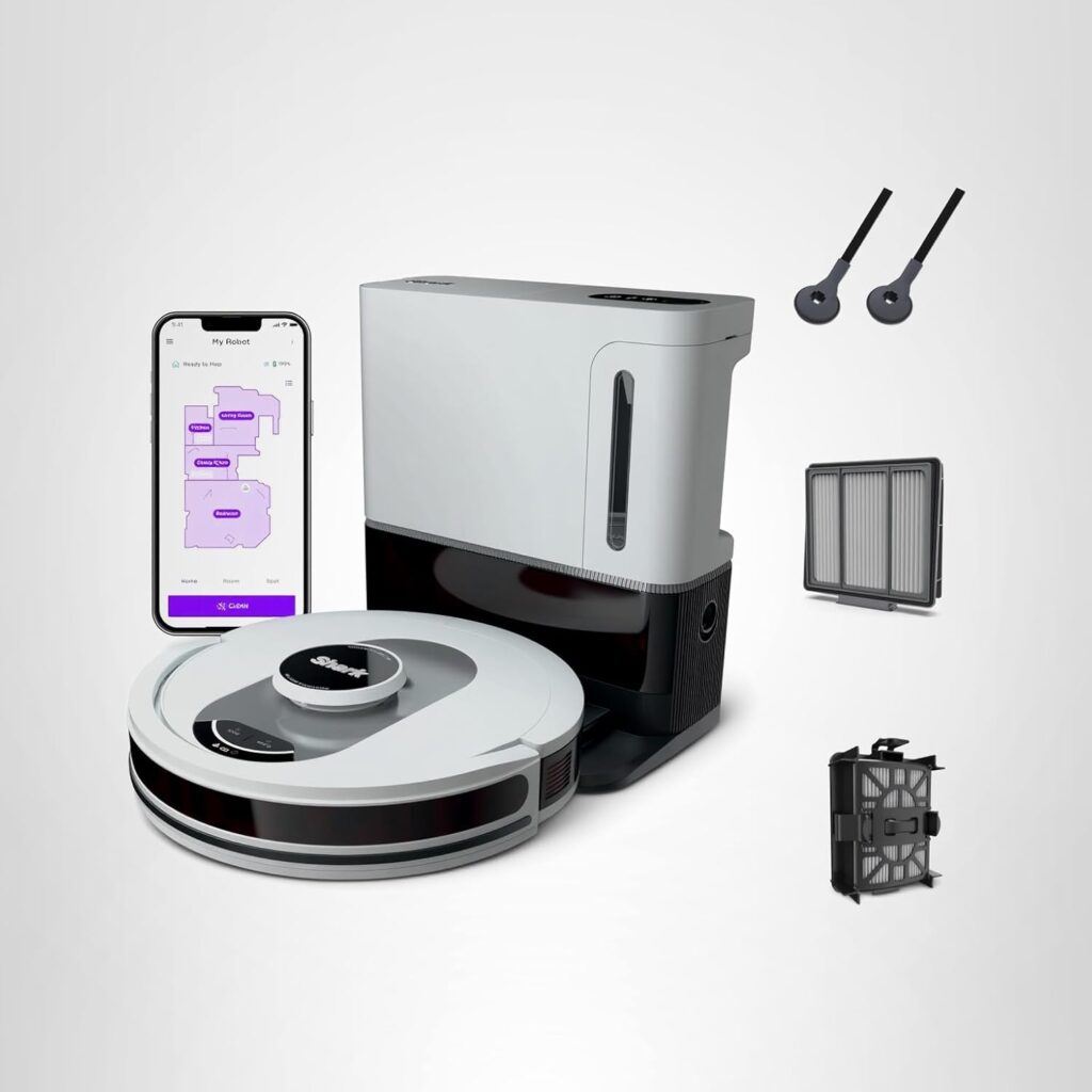 A white robotic vacuum with its charging and cleaning dock, two spare side brushes, a filter, a dustbin, and a smartphone displaying the vacuum's mapping app on a white background.