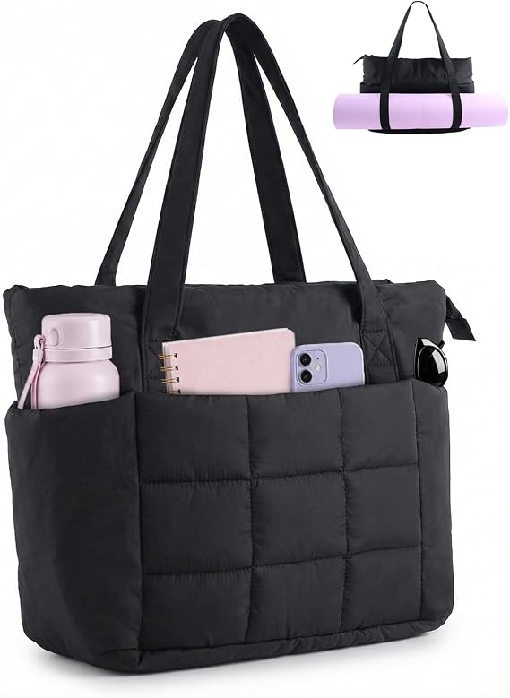 A black quilted tote bag with exterior pockets holding a water bottle, notebook, and smartphone. An inset shows the bag carrying a rolled-up yoga mat beneath the handles.