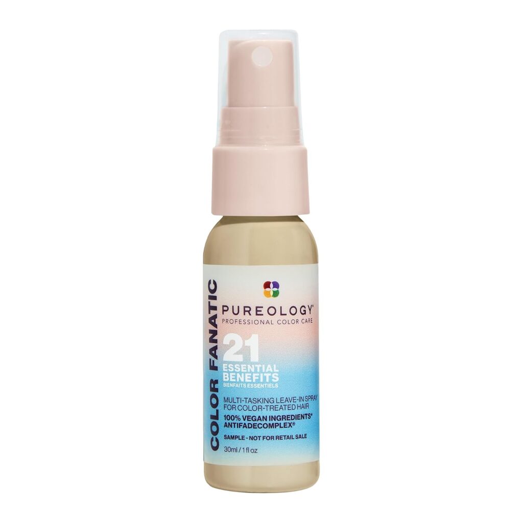 A small bottle of Pureology Color Fanatic leave-in spray with a pink cap, featuring "21 Essential Benefits" text and a gradient blue and pink label.