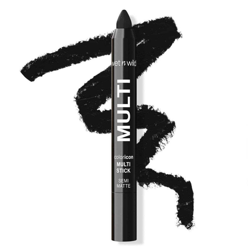 A black makeup stick labeled "Wet n Wild MULTI coloricon MULTI STICK SEMI MATTE," with a black scribble behind it showing the product’s texture and color, perfectly illustrates the versatility of the wet n wild Color Icon Cream Eyeliner Eyeshadow Multi-Stick.