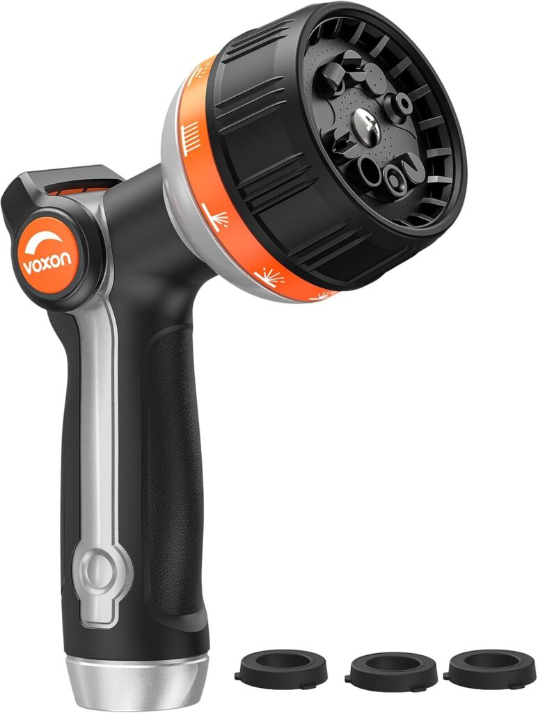 A black and orange Voxon garden hose nozzle with a rotating head, ergonomic handle, and three black rubber washers placed beside it.