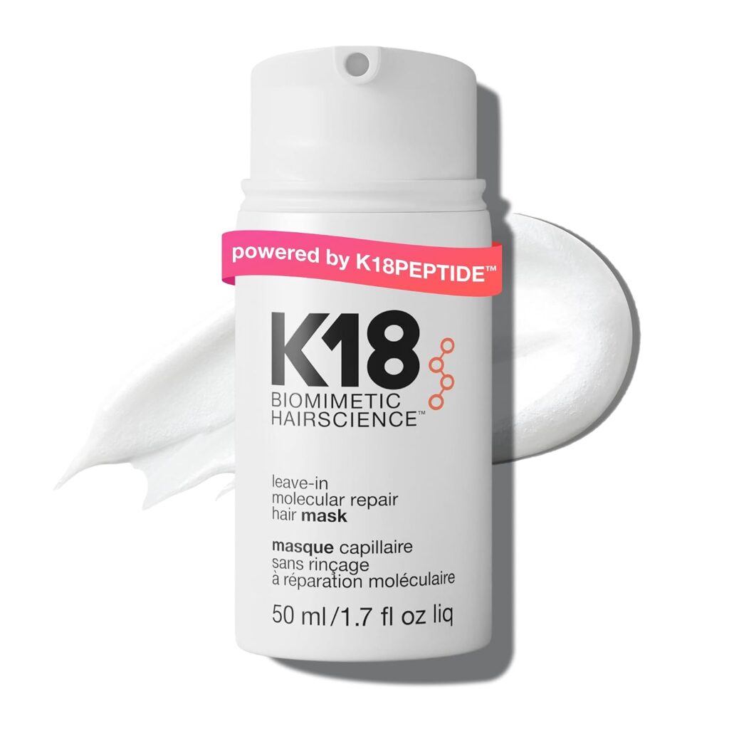 White bottle of K18 Biomimetic Hairscience leave-in molecular repair hair mask, 50 ml, with a smear of white cream in the background and a pink label reading "powered by K18PEPTIDE™" across the top.