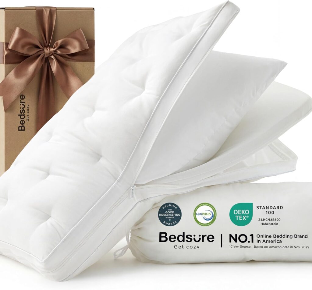 Two white pillows, one in a clear zippered bag, next to a brown BedSure box with a ribbon. Labels show OEKO-TEX and GREENGUARD certifications and "#1 Online Bedding Brand in America.