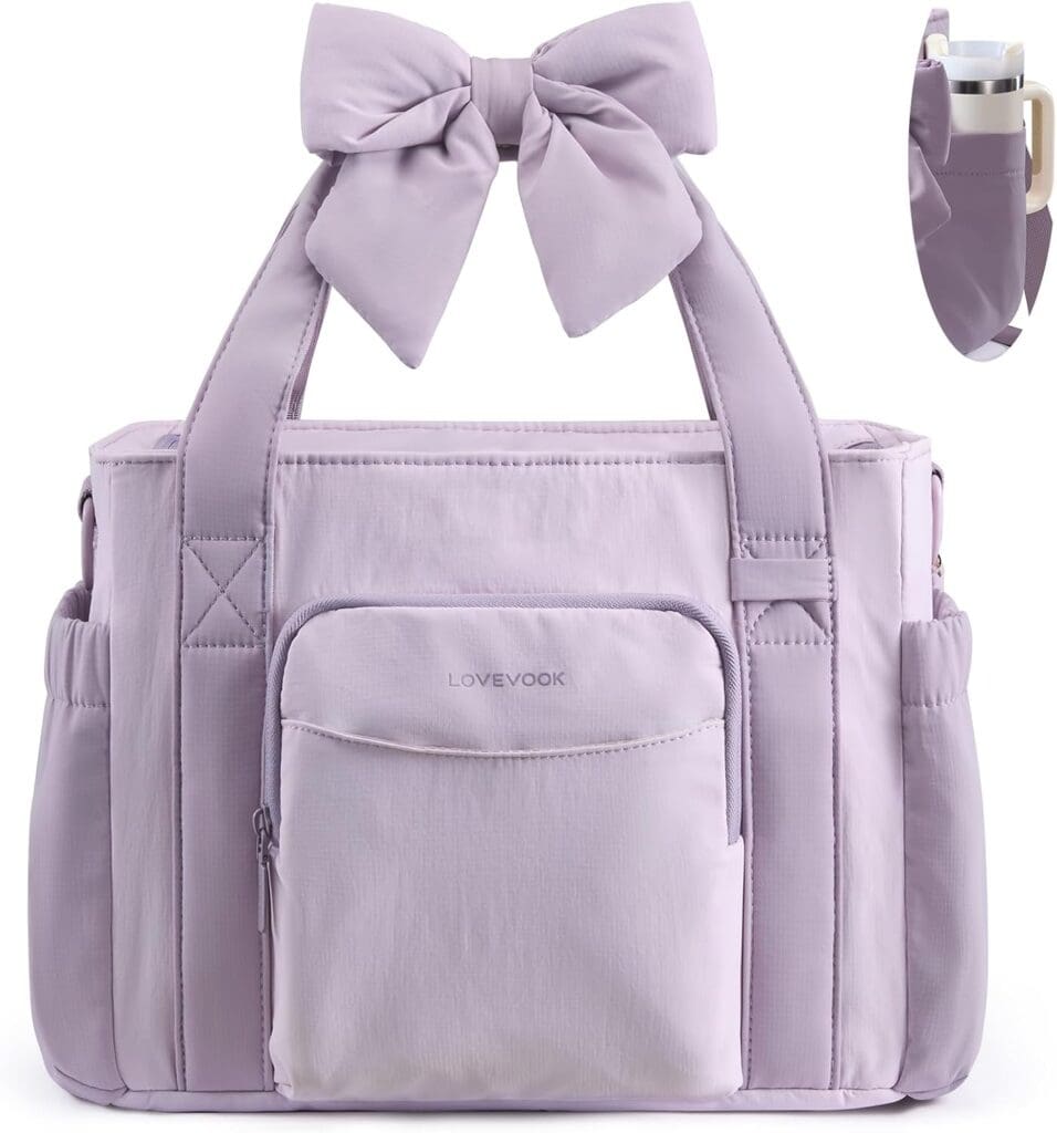 Light purple diaper bag with a front pocket, side pockets, and a large bow on the handle. A close-up shows a water bottle in a side holder. The bag has the brand name "LOVEVOOK" on the front pocket.