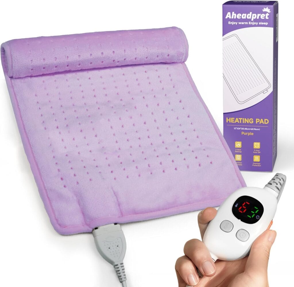 A purple heating pad with a textured surface is shown alongside its packaging. A hand holds a white digital controller with display and buttons, connected to the pad. The box reads "Aheadpret Heating Pad.