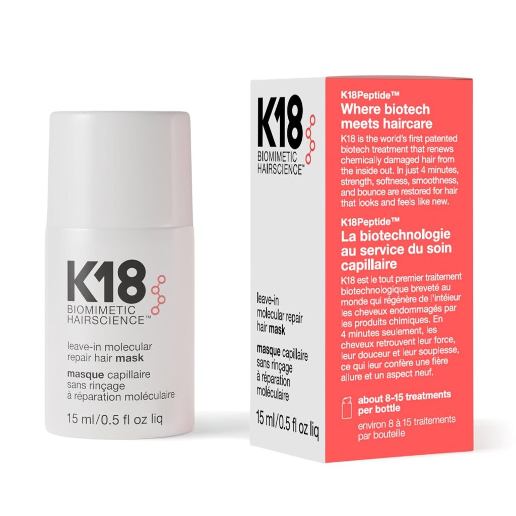 A white bottle and its box labeled "K18 Biomimetic Hairscience" leave-in molecular repair hair mask, 15ml. The box has red accents and text about haircare benefits.