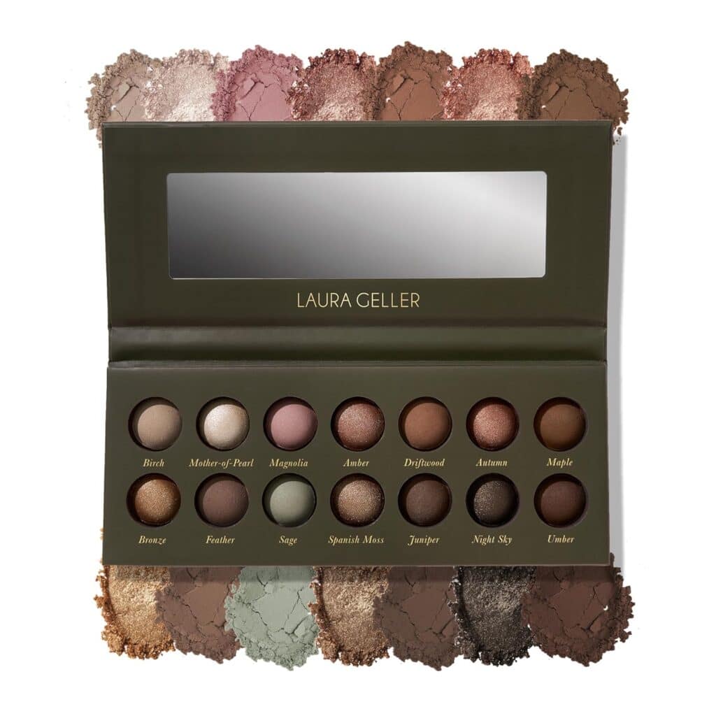 An open Laura Geller eyeshadow palette with 14 round, neutral-toned shades and a mirror inside the lid. Crushed samples of each shade are displayed above and below the palette.