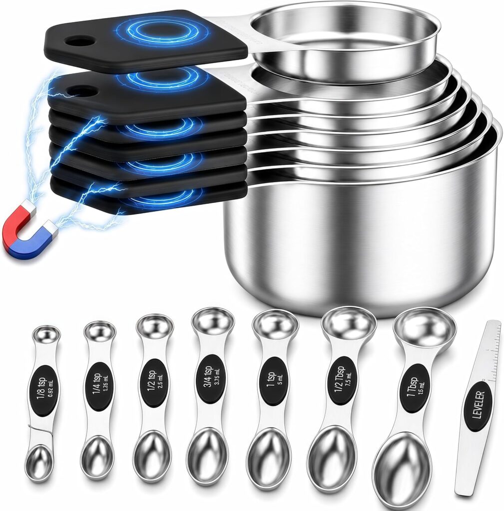 A set of stainless steel measuring cups and double-sided measuring spoons with black handles, some stacked. A magnet and electric effect highlight magnetic handles. A small metal scraper is also included.