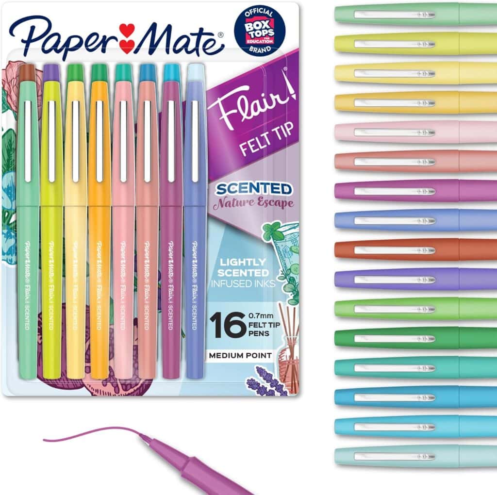 A 16-pack of Paper Mate Flair scented felt tip pens in pastel colors, arranged in the packaging and lined up beside it, with one purple pen uncapped and a wavy line drawn.