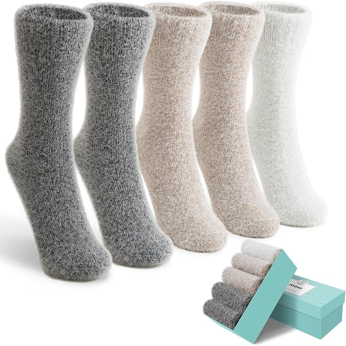 Five pairs of fuzzy socks in gray, beige, and off-white are displayed upright, with an open light blue box showing the same socks rolled up inside—perfect for grabbing during Wednesday Deals.