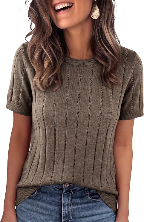Woman wearing a ribbed, short-sleeve olive sweater, blue jeans, and a teardrop-shaped earring, smiling with wavy brown hair against a white background—perfectly styled for those can’t-miss Friday Deals.