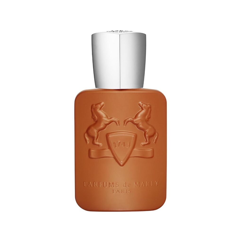 A matte, orange-brown perfume bottle with a silver cap evokes the essence of Premium Beauty. The front shows two raised horse figures and a shield with “1743,” highlighting the elegance of PARFUMS DE MARLY. The text below reads “Parfums de Marly Paris.” The background is plain white.