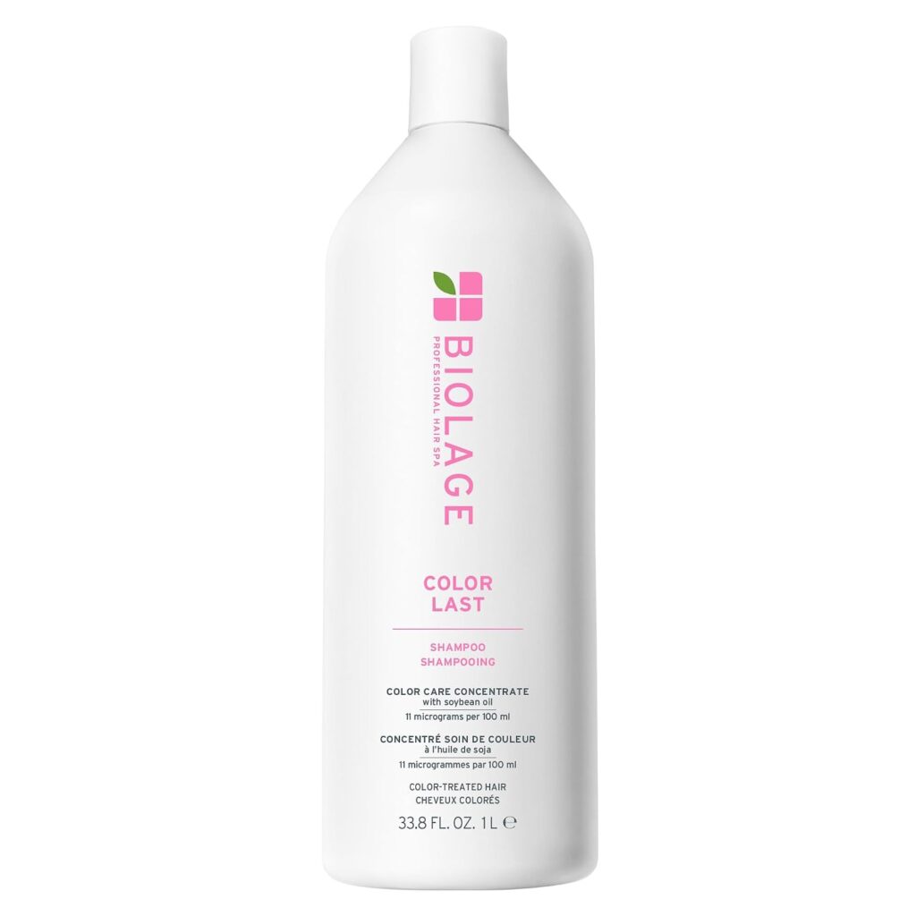 A white bottle of Biolage Color Last Shampoo, 33.8 fl. oz., with pink and green logo and text, designed for color-treated hair.