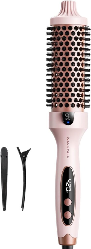 A pink and black heated round hair brush with an attached digital display, power button, vented barrel, and a black hair clip beside it.