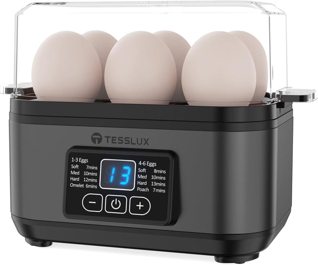 A black egg cooker with six eggs inside, a transparent lid, and a digital display showing “13.” Cooking times for different egg types and quantities are listed on the front panel.
