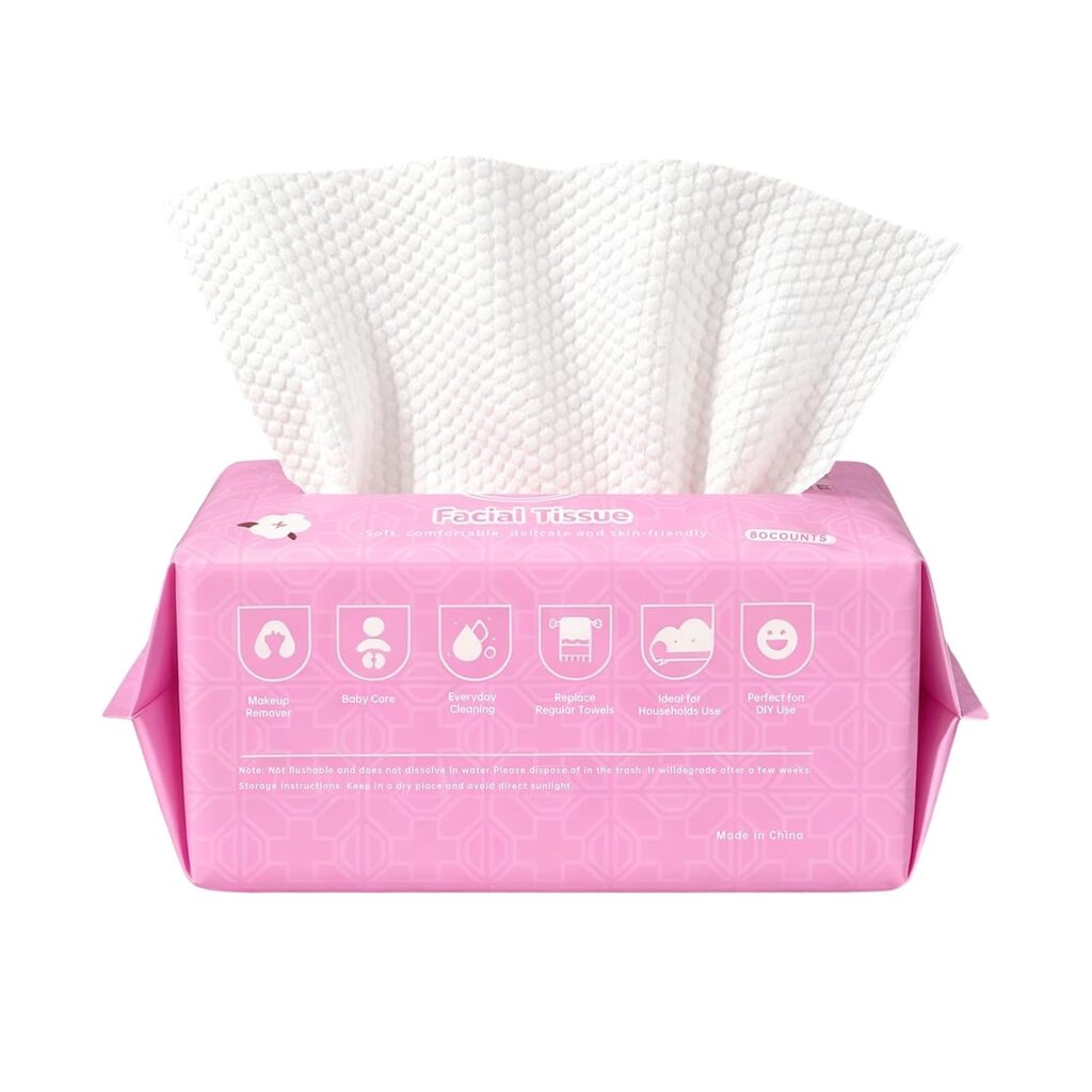 A pink box of facial tissues with white tissues emerging, featuring icons and labels for various uses like makeup removal, baby care, and hygienic purposes on the front. These face towels disposable are now available at 62% off, making them a convenient and affordable choice for everyday needs.