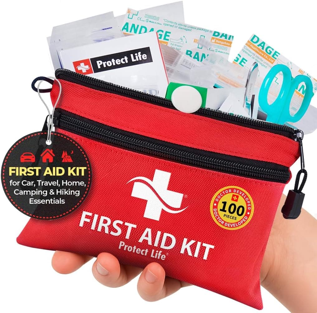 A hand holds a red first aid kit pouch labeled “FIRST AID KIT,” with medical supplies like bandages and wipes visible inside. The zippered, compact pouch is ideal for travel or emergencies, making it a smart addition to your essentials—especially when you take advantage of exclusive Wednesday Deals.