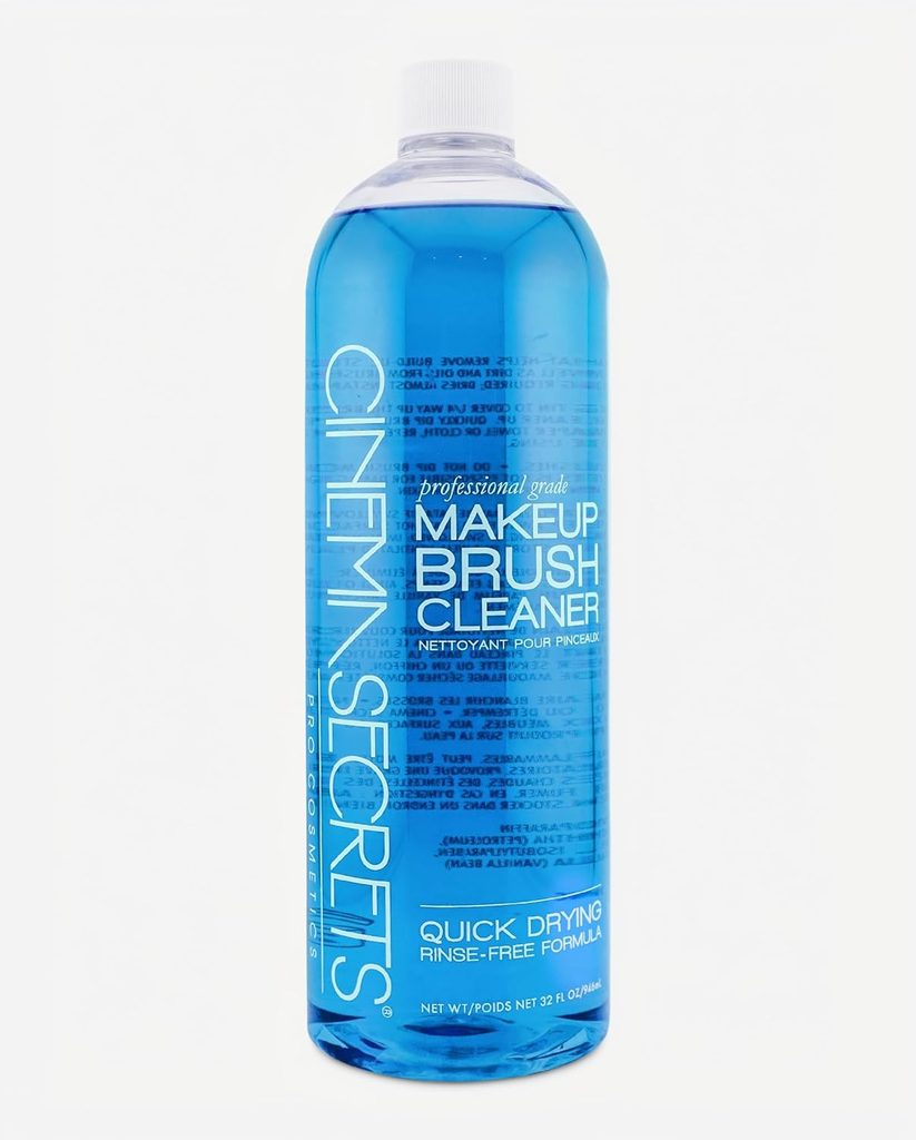 A large clear bottle filled with blue liquid labeled “Cinema Secrets Professional Grade Makeup Brush Cleaner” with text highlighting “quick drying” and “rinse-free formula,” perfect for stocking up during Wednesday Deals.