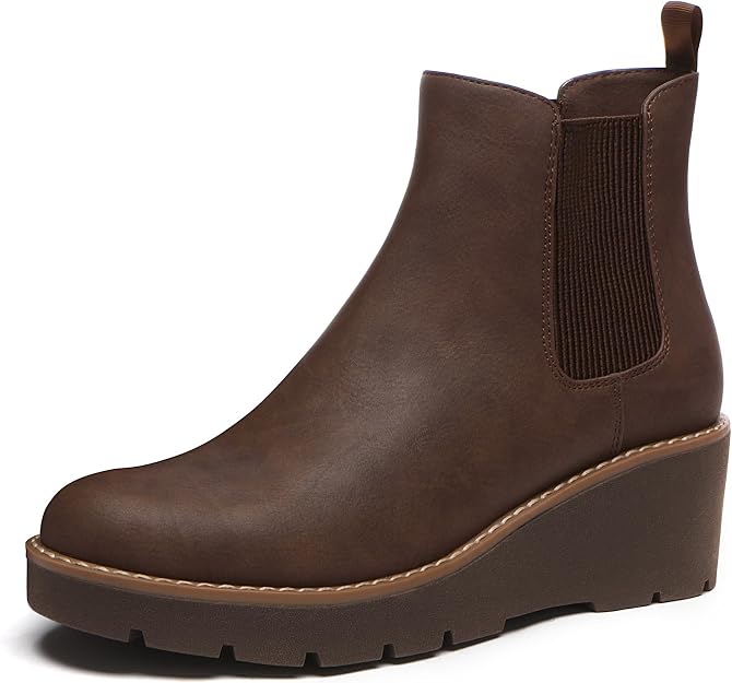 A brown leather Chelsea boot with an elastic side panel and a wedge heel, featuring a pull tab at the back and visible stitching along the sole.