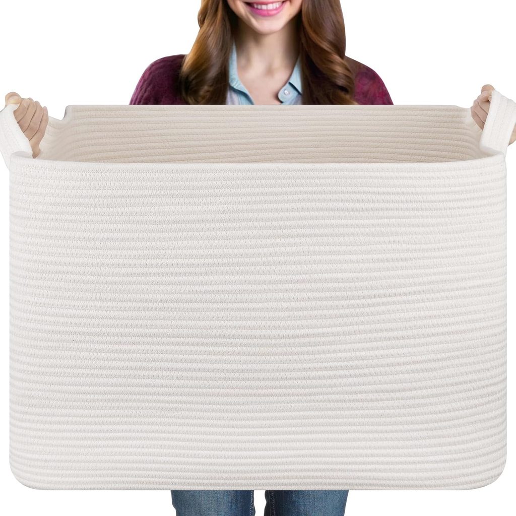A person holds a large, rectangular, white woven basket with handles, obscuring most of their body except part of their face, arms, and legs—ready to discover the best Thursday Deals tucked inside.