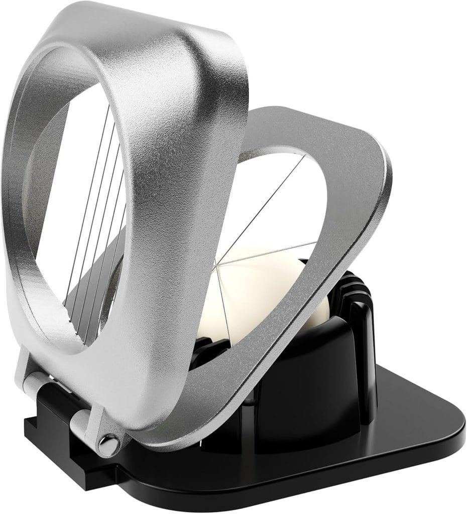 A metal egg slicer with a white egg inside, featuring thin wires for slicing and a black base for stability.