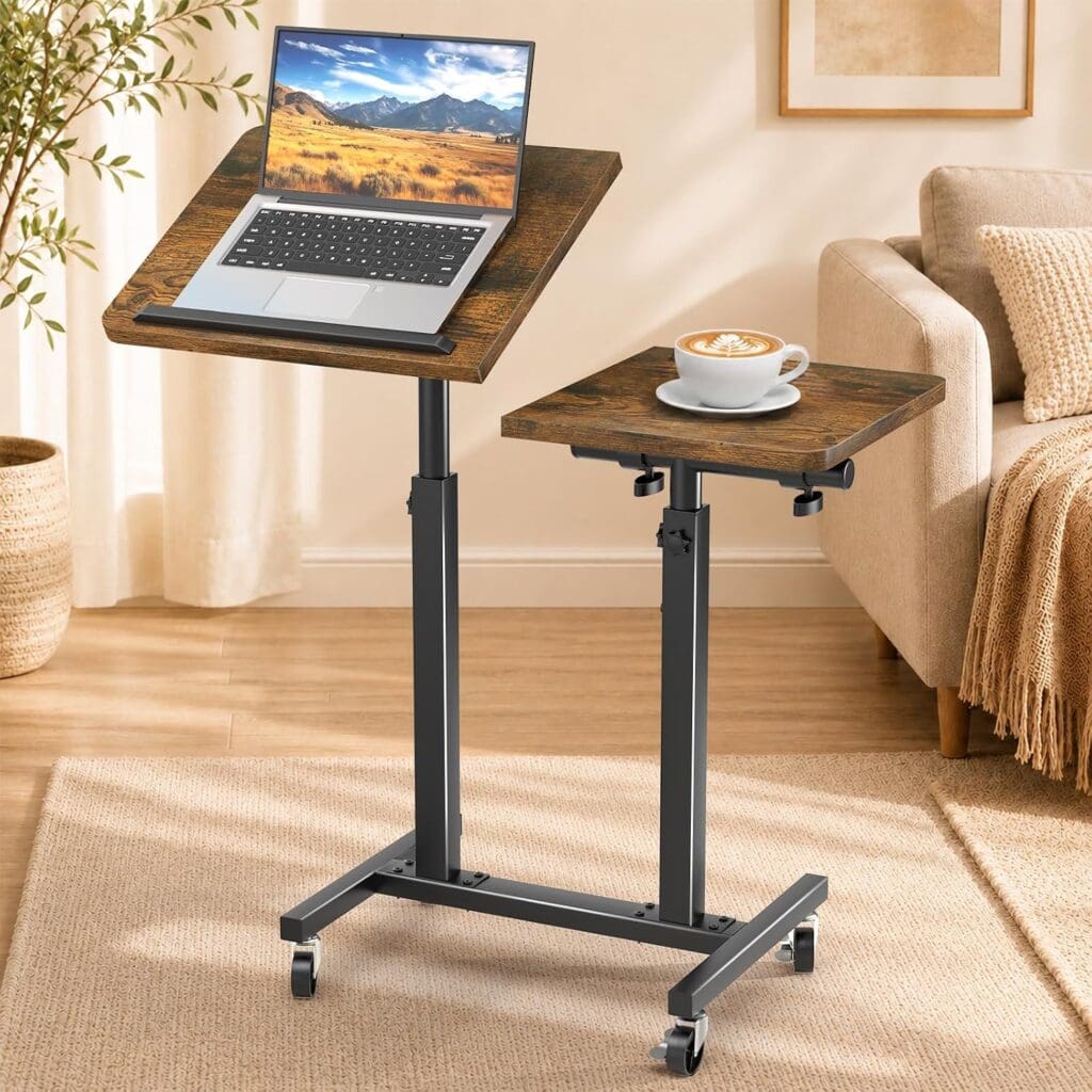 Adjustable rolling laptop desk with two wooden surfaces, one holding a laptop and the other a cup of coffee, in a cozy living room with a sofa, plant, and framed art in the background—perfect for upgrading your workspace during Monday Deals.