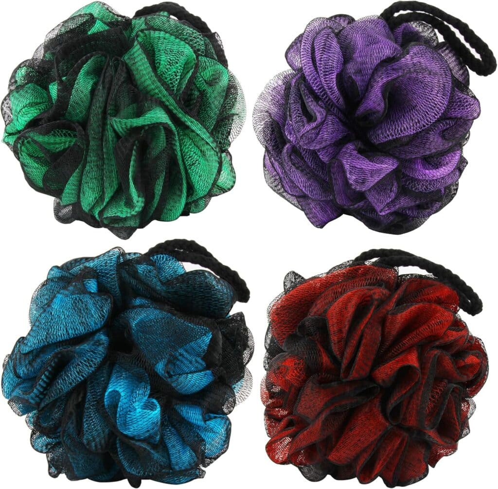 Four mesh bath poufs in green, purple, blue, and red, each with a black hanging loop, are arranged in a square on a white background.