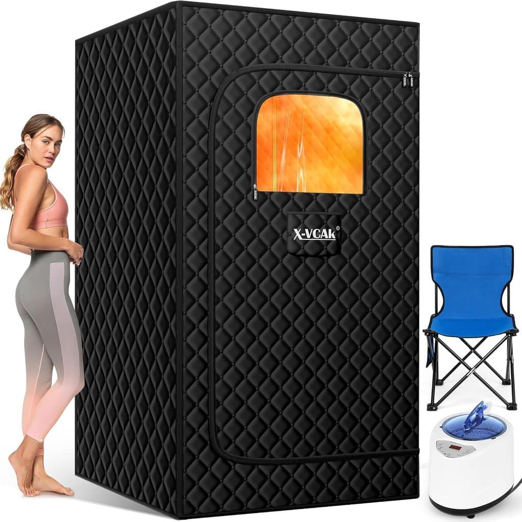A woman stands beside a black portable sauna tent with a small window. A blue folding chair and a white steam generator are placed next to the tent, perfect for relaxing after enjoying Thursday Deals.